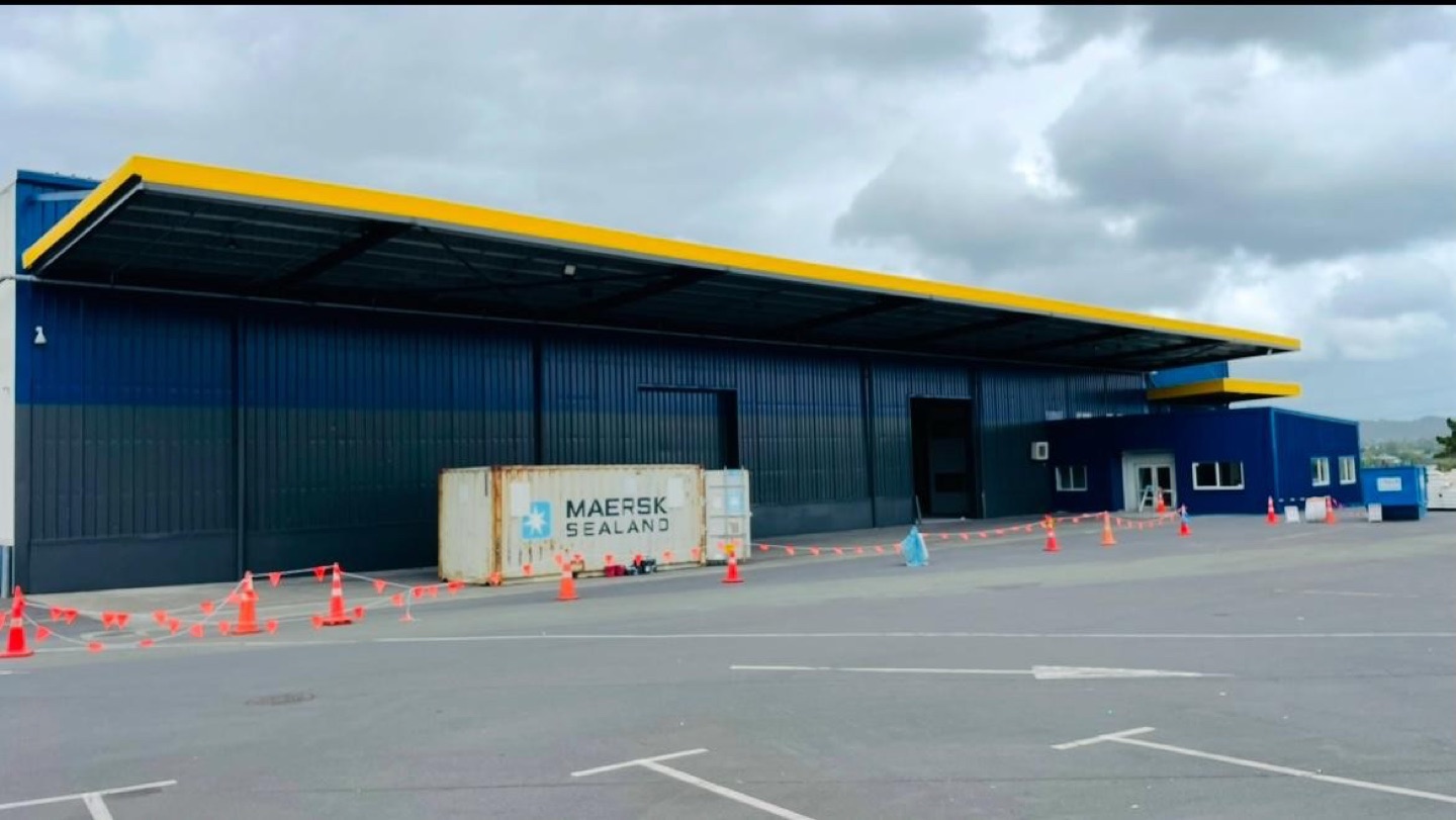 Completed Auckland commercial building exterior with dark blue and yellow painted finishes