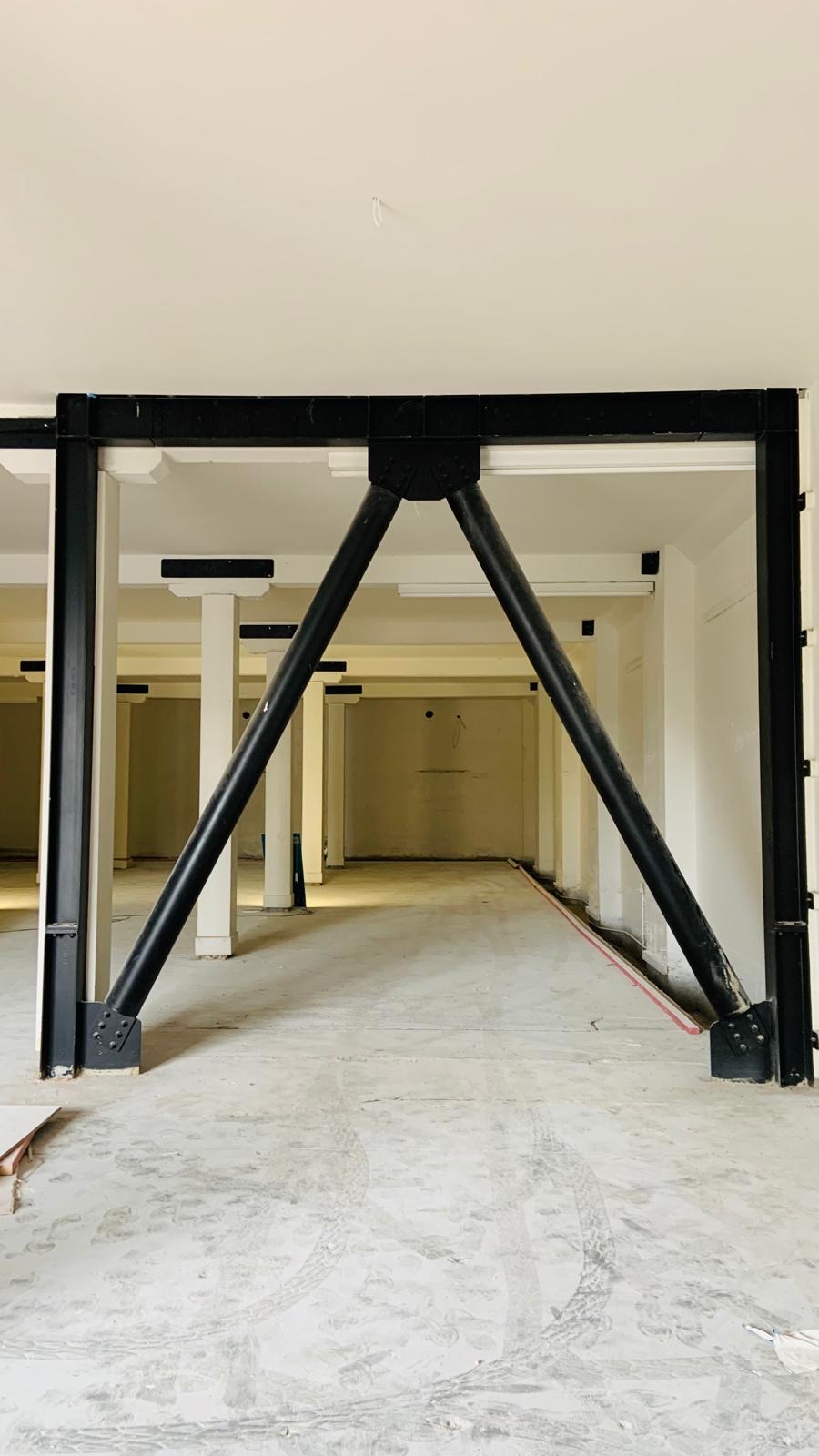 Commercial interior after GIB stopping and plastering with a smooth finished ceiling