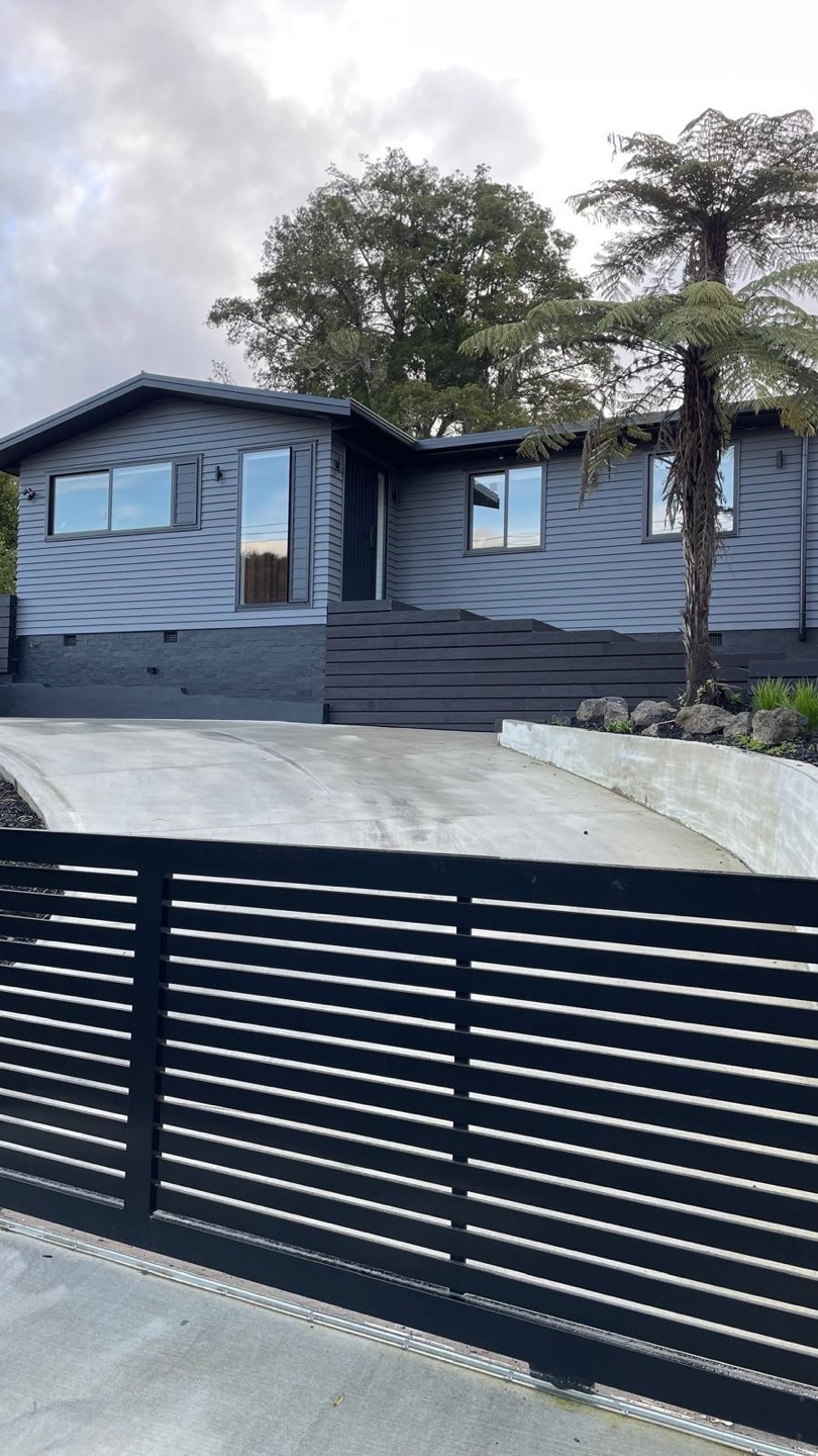 Completed Auckland home exterior with a dark grey painted finish
