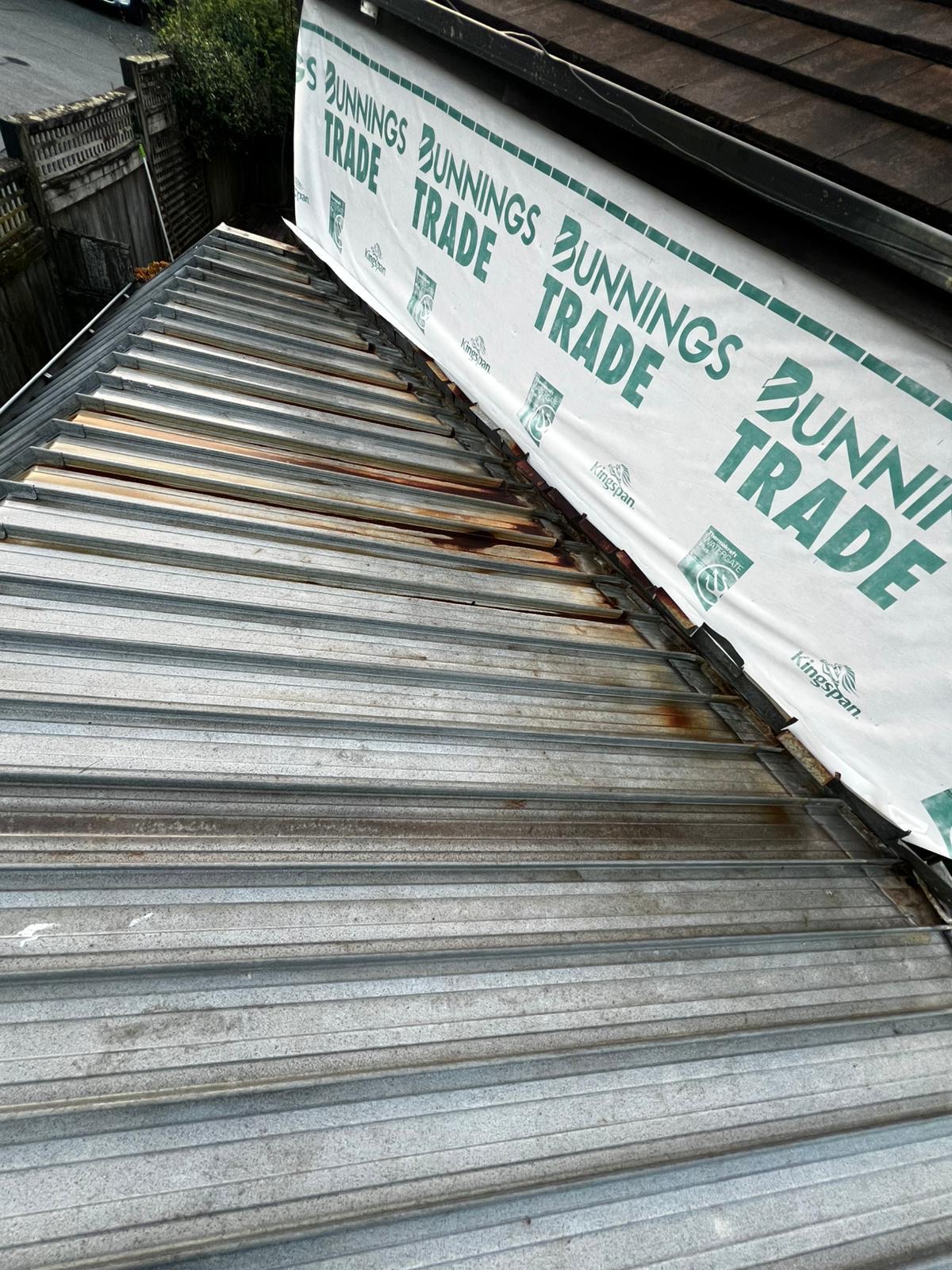 Second view of weathered metal roofing before restoration